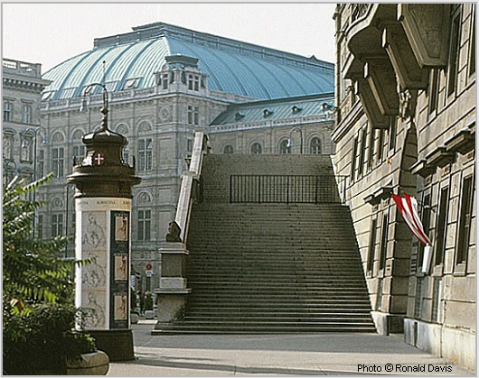 Entrance to the Albertina (right), Vienna. Column with posters announcing the museum's exhibitions "Raphael in der Albertina," and "Stanley Roseman - Zeichnungen aus Klostern," 1983. Photo  Ronald Davis